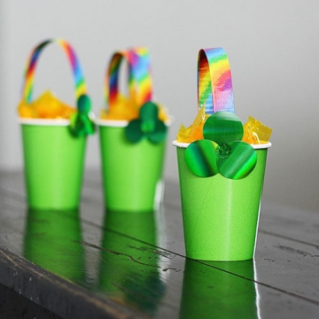 Green mini cups with clover and rainbow decorations.